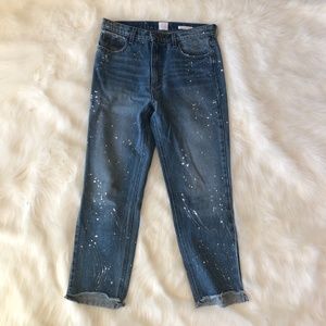 Splatter painted jeans with rip under butt